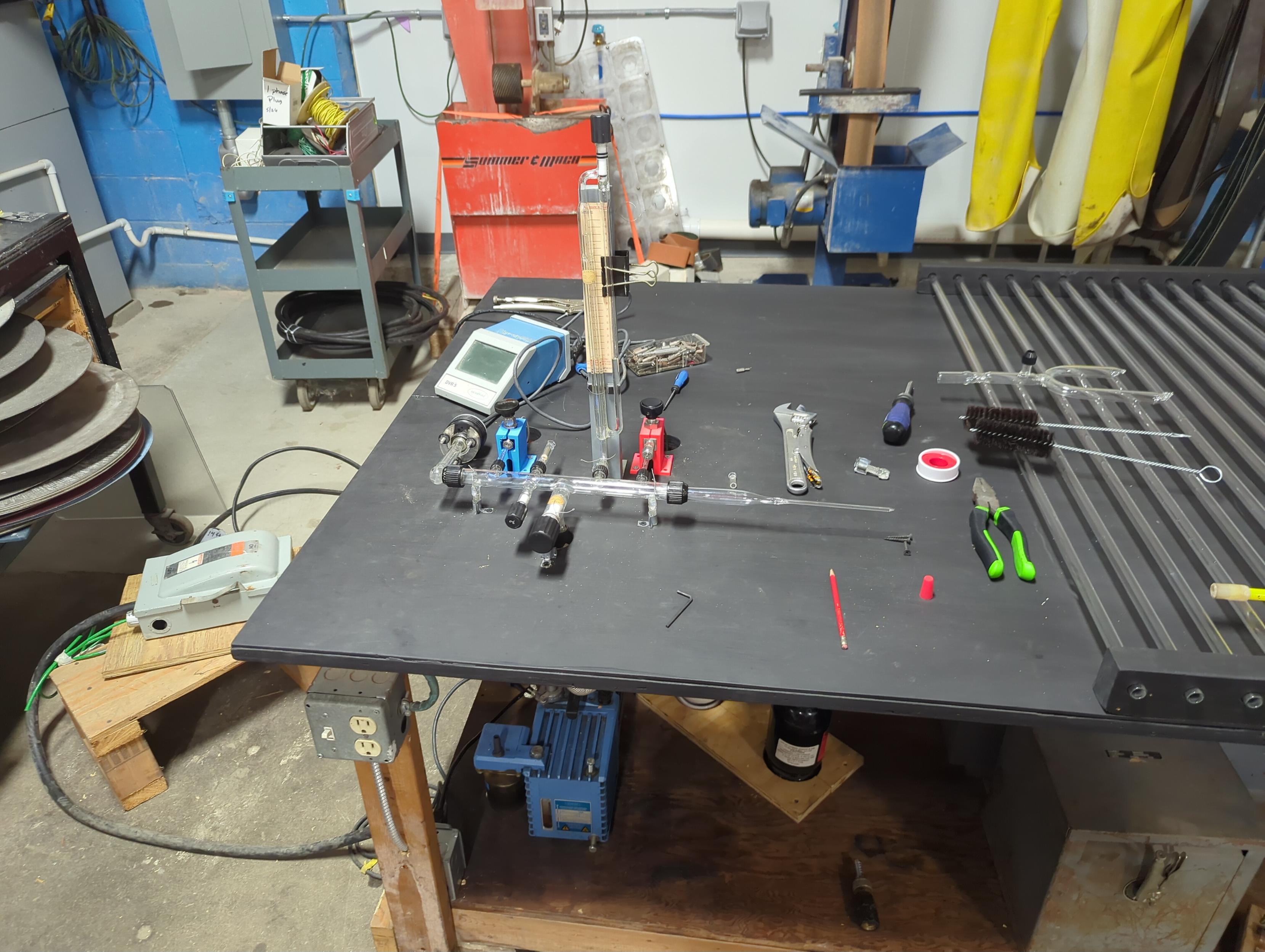 neon manifold with clean, smooth, black table. Katie's sidearm isnt ready. Gas tanks under the table for accessibility