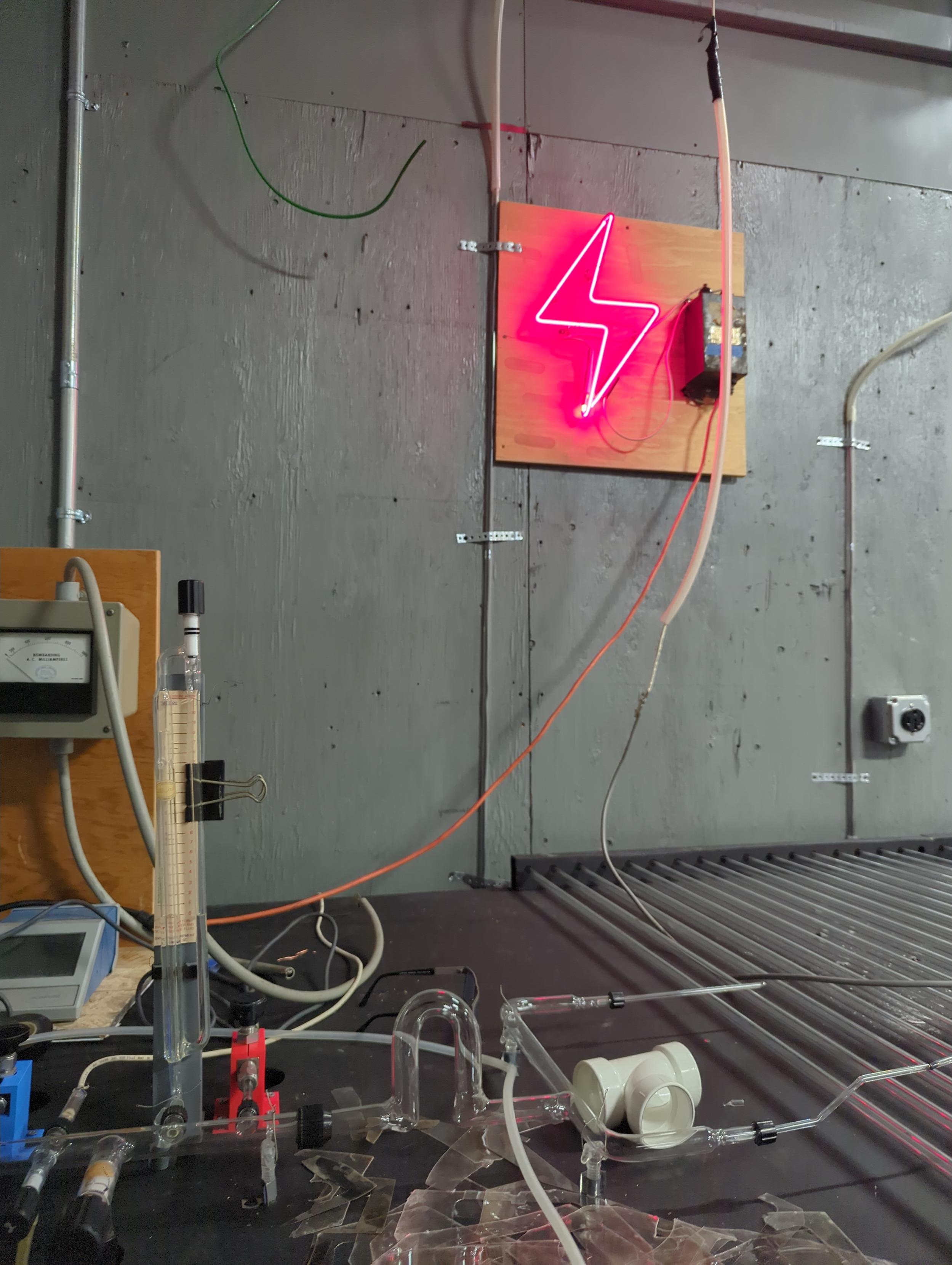 view from the bombarders chair, with the buttons at the ready to engage. You can see the safety light that only comes on when the buttons could engage the coil. I want to bend them a cursive "stay back" Liesl (a student) drew the lightning bolt.
