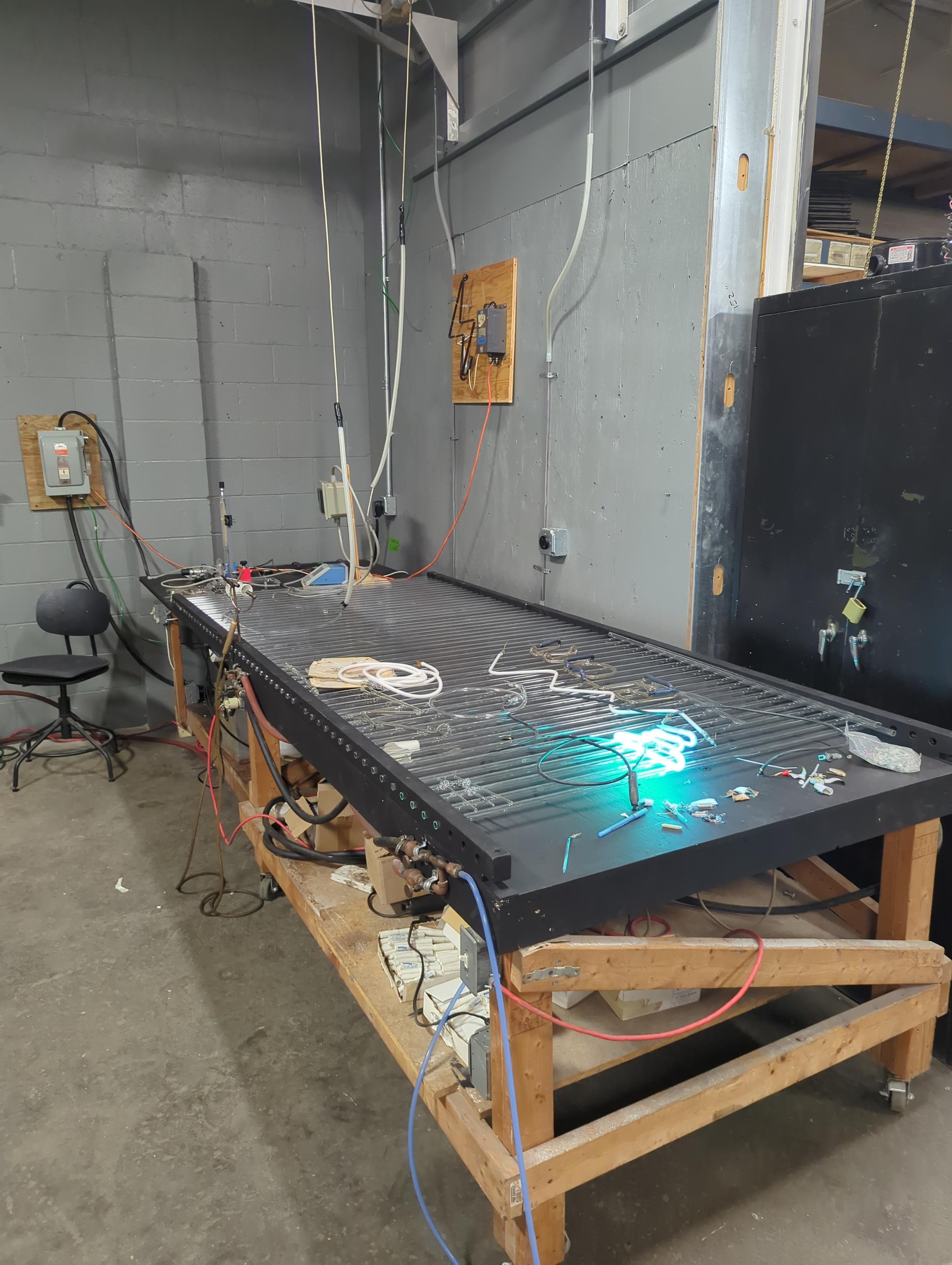 bombarding table and chair with disconnect switch and aging table (at the end of the bombarding table) the turquoise tube on the bombarding table is a tube that I made for the diner where I get my breakfast and will meet students for a breakfast and neon installation demo at the Diner (Tommy's) for the last day of class.