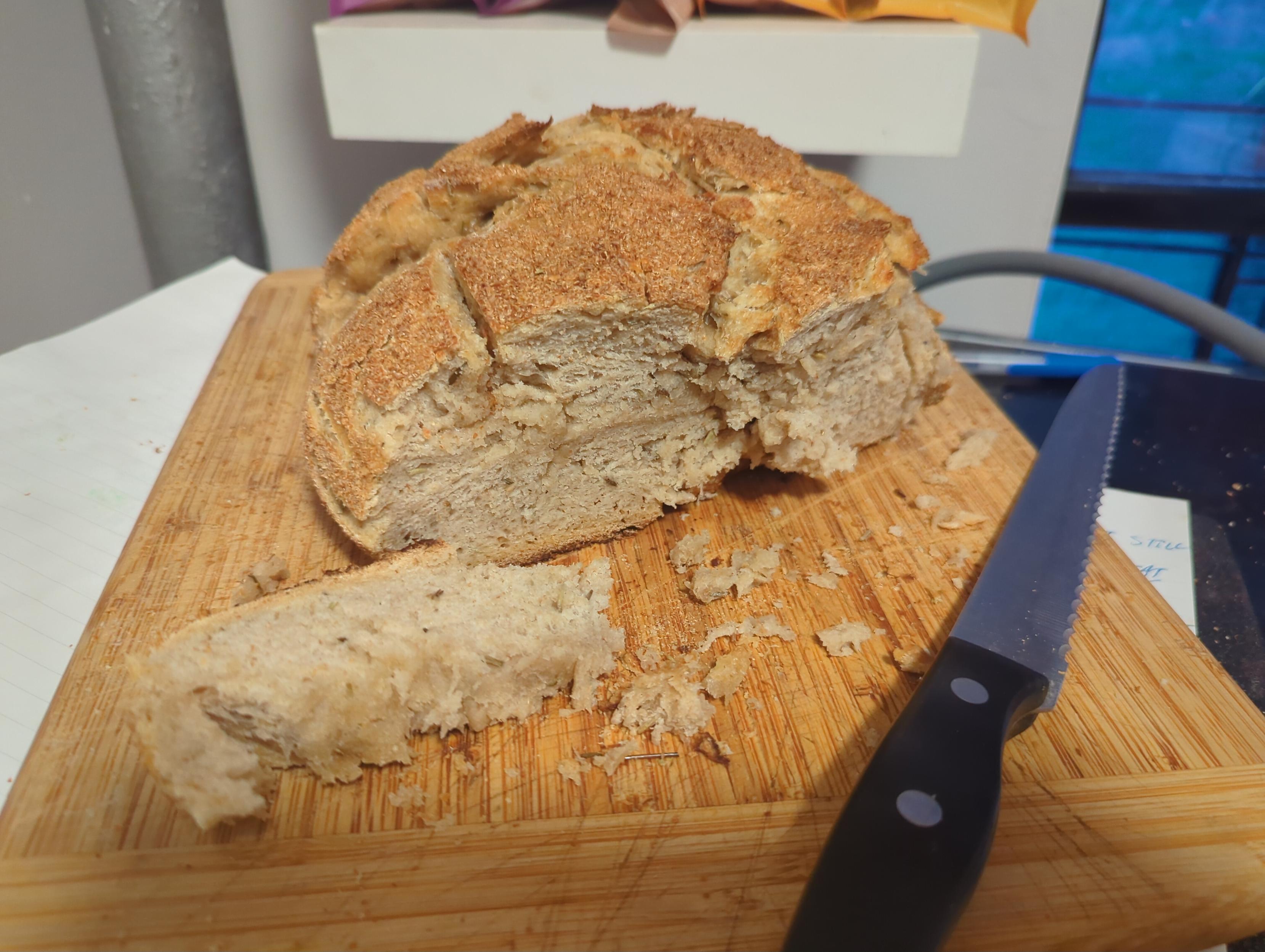 wheat bran covered rosemary butter sourdough with its somewhat dense crumb exposed.